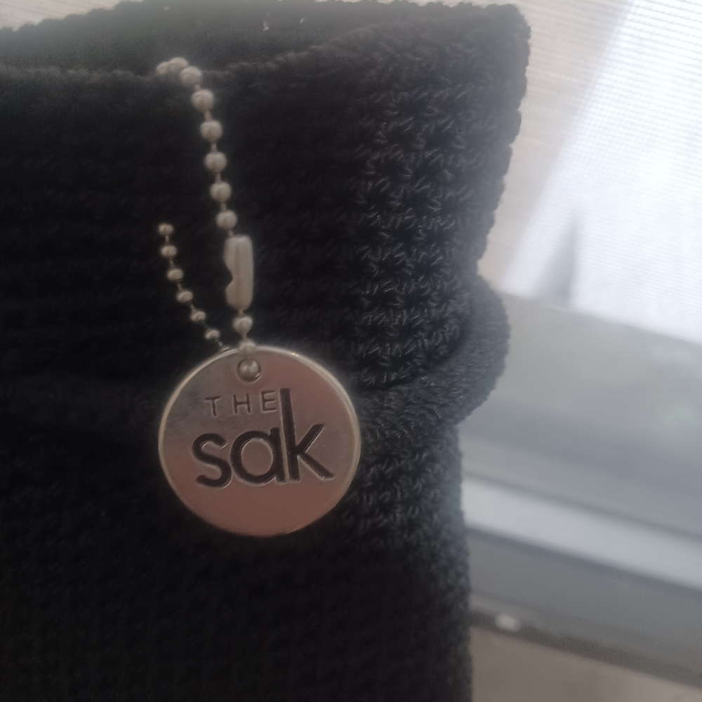 Calvin Klein Sak bag, black woven and braided with tie closure.